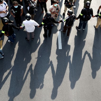 Security personnel form a human chain during a Thai anti-government mass protest in Bangkok in October on the 47th anniversary of the 1973 student uprising. Photo: Reuters