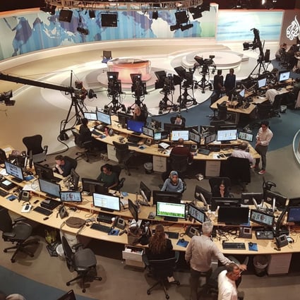 Al-Jazeera staff work at their TV station in Doha, Qatar. File photo: AP