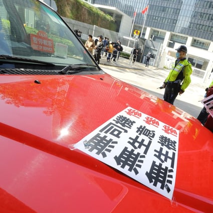 Taxi drivers gather outside government offices to petition for more financial support. Photo: Dickson Lee