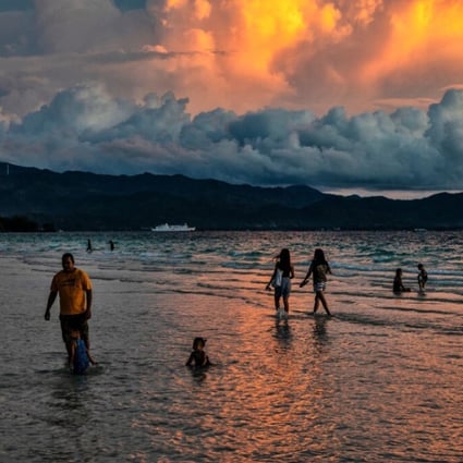 Domestic tourists at White Beach in Boracay, the Philippines in October. The popular tourist destination has been devastated by the Covid-19 pandemic, and domestic visitor numbers are too low to sustain many businesses. Photo: Getty Images