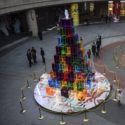 An modern take on a Christmas tree towers over visitors outside a Shanghai shopping mall. Photo: Bloomberg
