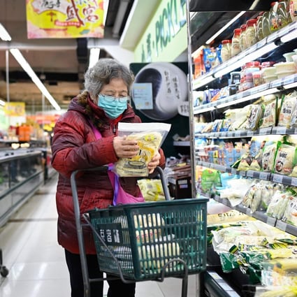 An elderly woman shops at a supermarket in Beijing on December 17. Photo: AFP