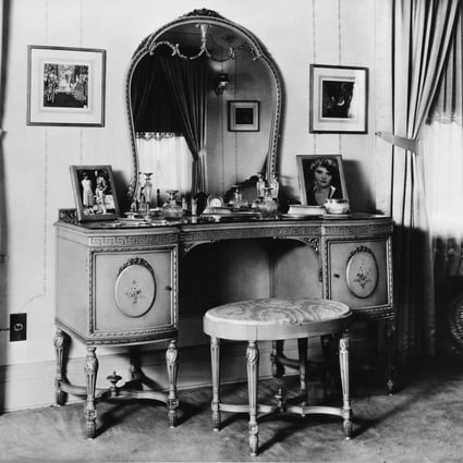 A dressing table with ornate leg styling and floral door panels, circa 1920. Photo: Getty Images