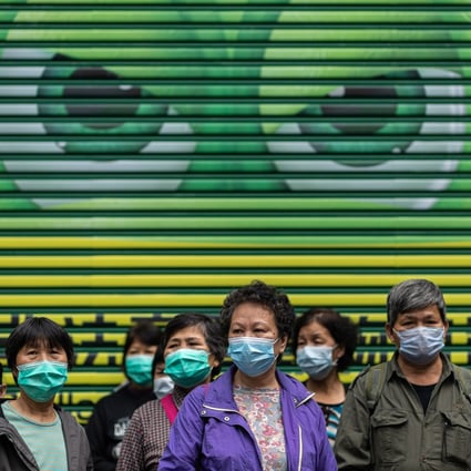 Street cleaners wait in line to receive free face masks in Hong Kong on February 14. Photo: EPA-EFE