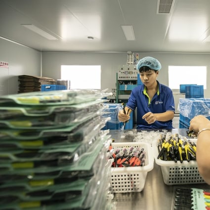Employees sort toothbrushes on a production line in Yangzhou, Jiangsu Province, China. Photo: Bloomberg