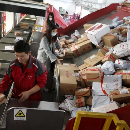 Workers sorting out packages for delivery at JD.com's Yizhuang Smart Delivery Station in Beijing on November 11, 2020. Photo: Simon Song