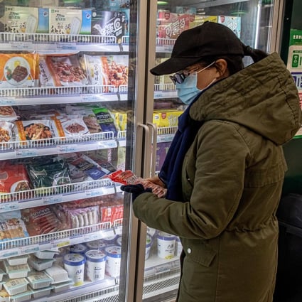 A woman shops at a frozen food section at a store in Beijing. Photo: EPA-EFE