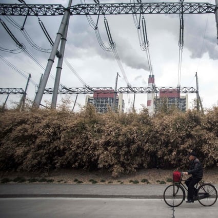 A man cycles past the Waigaoqiao Power Generator Company coal power plant in Shanghai. Even with China’s heightened pledges on reducing greenhouse gas emissions and the prospect of the US rejoining the Paris climate agreement, greater US-China cooperation is essential to addressing climate change before it is too late. Photo: AFP