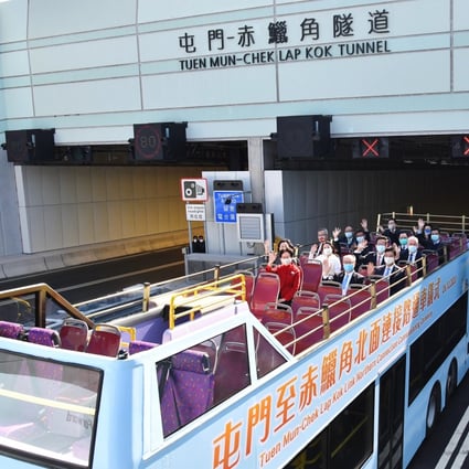 Chief Executive Carrie Lam (front, in red) and other officials ride a double-decker bus to attend a ceremony to mark the commissioning of the Tuen Mun-Chek Lap Kok Link Northern Connection, in Hong Kong on December 26. Photo: Xinhua