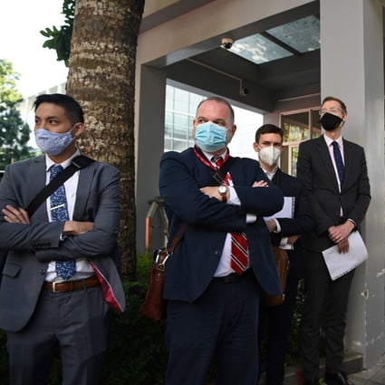 Diplomats from the US, Britain, Australia, Canada, Portugal and the Netherlands wait outside the Yantian People’s Court on Monday. Photo: AFP