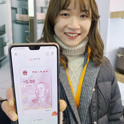 A woman in Suzhou, China, shows a smartphone app that allows its user to buy things with the digital yuan. This is part of an ongoing trial of the new currency. Photo: Kyodo