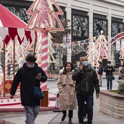 Shoppers walk through a festive market in Shanghai on December 19, 2020. Photo: Bloomberg
