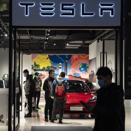 Shoppers and employees inside a Tesla showroom in Shanghai. Photo: Bloomberg