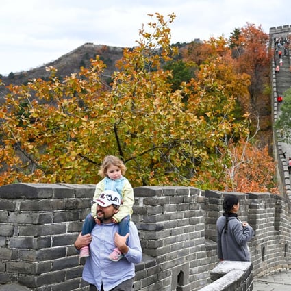 Tourists take in the autumn scenery at the Mutianyu section of the Great Wall on the outskirts of Beijing. Photo: Xinhua