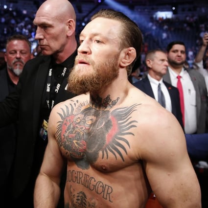 Conor McGregor celebrates his first round TKO victory against Donald Cerrone as he exits the arena at UFC 246. Photo: AFP
