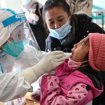 A medical worker takes a swab sample from a child to test for Covid-19 in Shenyang, China’s northeast Liaoning province on Thursday. Photo: AFP