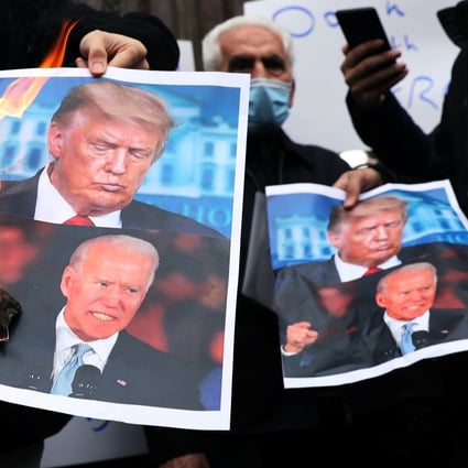 Iranian protesters burn pictures of Biden and Trump during a November 28 demonstration against the killing of the country’s top nuclear scientist, Mohsen Fakhrizadeh. Photo: Reuters