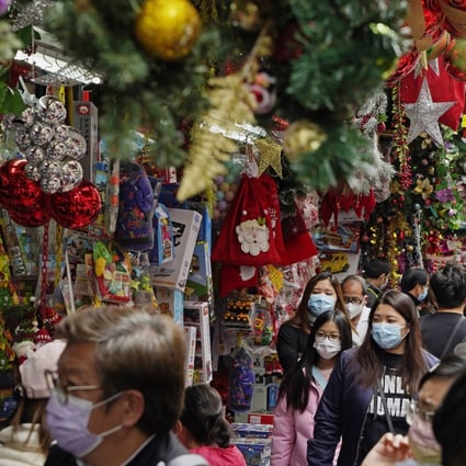 People wearing face masks shop for decorations ahead of Christmas in Hong Kong on December 19. An estimated 6 million face masks have been discarded every day in the city during the pandemic. Photo: AP