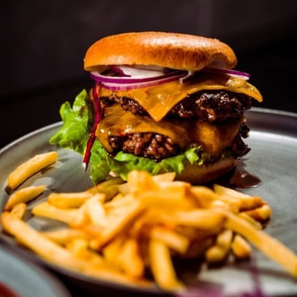 Dishes like this white truffle double cheeseburger may be delicious, but they are unlikely to make you feel as full as an unprocessed meal. Photo: @emanuelekstrom/Unsplash