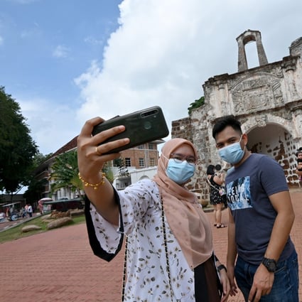 People take selfies at a tourist attraction in Malacca, Malaysia, in December 2020. Photo: Xinhua