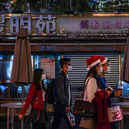 People pass a closed restaurant in Tsim Sha Tsui, Hong Kong. Photo: Bloomberg