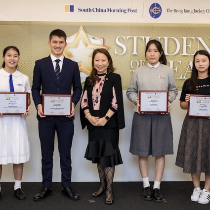(From left) Student of the Year Awards winners Chloe Yeung, Raymond Yeung, Mary To, and Chan Tsz-kiu along with Judge Irene Chan (centre), head of public affairs at the Hong Kong Jockey Club. Photo: Kwok Wing-hei