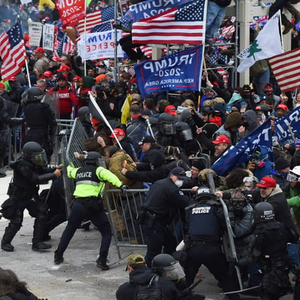 Supporters of outgoing President Donald Trump clash with police and security forces as they storm the barricades on their way to the US Capitol in Washington on January 6. Photo: AFP