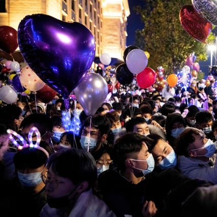 People wearing face masks attend a New Year countdown in Wuhan, China, on December 31, 2020. While international investors are flocking to China’s stock market, attracted by the country’s economic indicators, eventually they will have to contend with the many economic challenges posed by the coronavirus pandemic globally. Photo: AFP