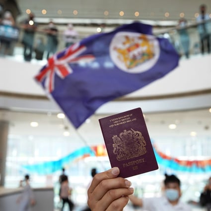 A protester holds up a BN(O) passport during an anti-government demonstration at IFC Mall on May 29, 2020. The British government has offered BN(O) passport holders the chance to settle in Britain and apply for citizenship. Photo: Winson Wong