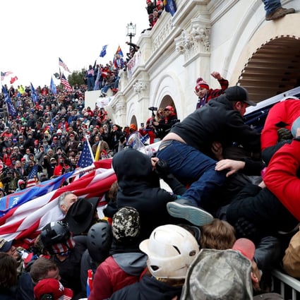 Pro-Trump protesters storm into the US Capitol during clashes with police on Wednesday. Photo: Reuters