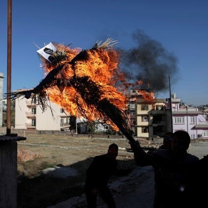 Protesters affiliated with a faction of the ruling Nepal Communist Party burn an effigy of Prime Minister K.P. Sharma Oli in Kathmandu on Thursday in protest over the dissolution of parliament. Photo: Reuters