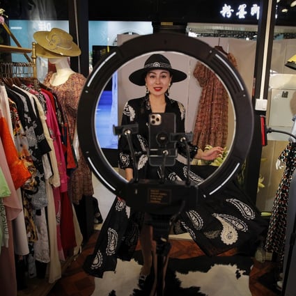 Retailer Song Huiyan live-streams modelling her dresses to clients from her shop in Beijing. Photo: AP