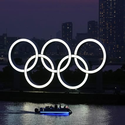 The Olympic rings float in the water at sunset in the Odaiba section in Tokyo last June. The Games have been postponed to July 23-August 8. Photo: AP