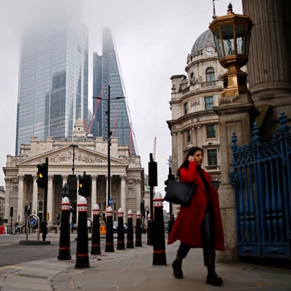 A pedestrian walks near the Royal Exchange and the Bank of England in the City of London amid a lockdown. Photo: AFP