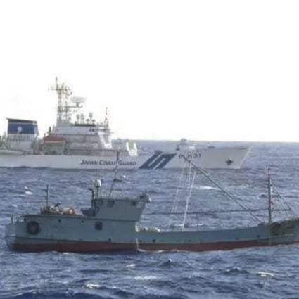 The Japanese coastguard apprehends a Chinese fishing boat (front) in its nearby waters. Photo: Japan Coastguard.
