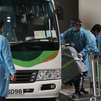 Passengers at Hong Kong airport load their luggage into a bus which will transport them designated quarantine hotels on December 22. Photo: Nora Tam