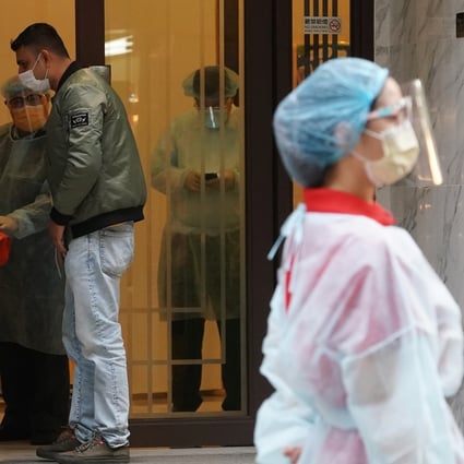 A staff member in protective gear waits for arriving guests at the Ramada Hong Kong Grand in North Point, a designated quarantine hotel, on December 21. The Hong Kong government has since tightened its quarantine requirements for arrivals. Photo: Felix Wong