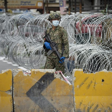A soldier on guard in the locked-down area of Selayang Baru on the outskirts of Kuala Lumpur in April 2020. Photo: AP