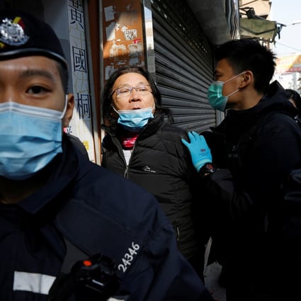 Daniel Wong is escorted by police to his office for a police search on Thursday. Photo: Reuters