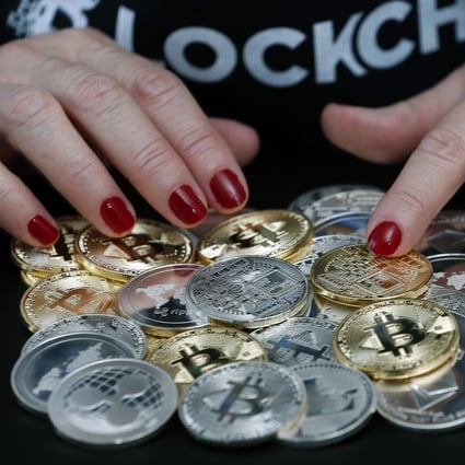 Visual representations of various cryptocurrencies on display in Paris, France. Photo: Getty Images
