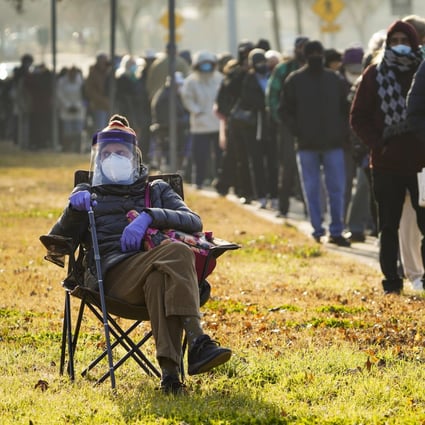 Florence Mullins, 89, sits in a chair as a family member holds her place in a queue to receive a Covid-19 vaccine at Fair Park in Dallas on January 11. Photo: AP
