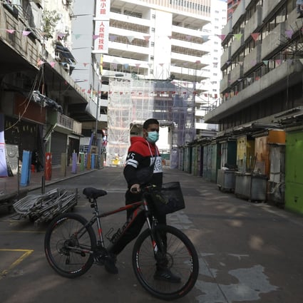 A man wheels his bicycle across a street in Jordan, where most shops are closed after a cluster of Covid-19 cases were discovered in the surrounding areas, on January 19. Photo: Nora Tam