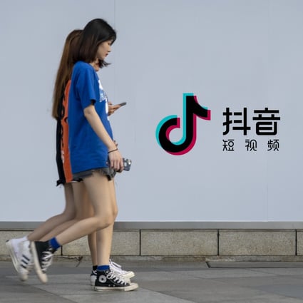 Pedestrians walk past an advertisement for ByteDance-owned short video-sharing platform Douyin, the sister app of TikTok, in the southern Chinese city of Guangzhou. Photo: Imaginechina via Agence France-Presse
