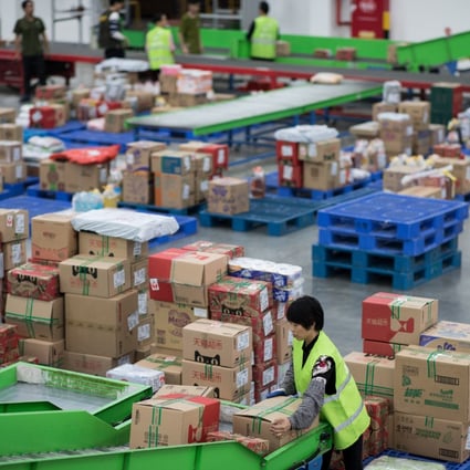 Workers in a Tmall warehouse gather orders from customers in Jiangmen, Guangdong province, on November 28, 2018. Alibaba’s Tmall and JD.com have been boosting their platforms for overseas brands as consumer goods imports surge in China during the coronavirus pandemic. Photo: EPA-EFE