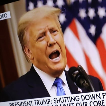 US President Donald Trump is seen on a television screen in the White House briefing room as he addresses the nation during his last day on Tuesday. Photo: TNS