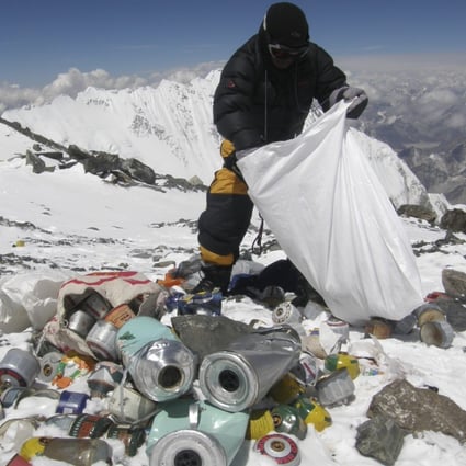A Nepalese sherpa collects garbage left by climbers at an altitude of 8,000 metres during a Mount Everest clean-up expedition. A local group plans to create art out of some of the waste left at the world’s highest peak. Photo: AFP