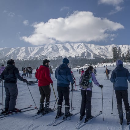 Tourists wait for their turn to use a ski lift on the slopes at Gulmarg, a winter sports resort in Indian-controlled Kashmir. With restrictions on overseas travel because of the coronavirus, domestic tourists have packed out hotels in the hill station to ski, sledge, snowboard and trek. Photo: AP