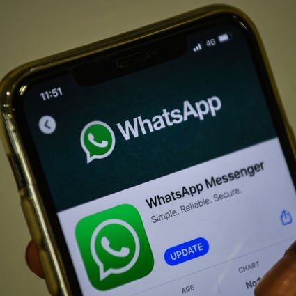 A user in Mumbai updates Facebook's WhatsApp application on his mobile phone. Photo: AFP