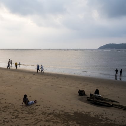 Local people walk along a beach in Goa, India. The popular tourist destination has been devastated by the Covid-19 pandemic that has destroyed Goa’s booming tourist industry. Photo: AFP