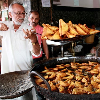 Frying mutton samosa in Bangalore. Samosas are called the “king of snacks” in India, but they originated in Egypt. Photo: Getty Images